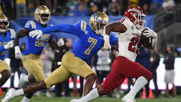 Sep 18, 2021; Pasadena, California, USA; Fresno State Bulldogs running back Ronnie Rivers (20) runs against UCLA Bruins defensive back Mo Osling III (7) in the third quarter at Rose Bowl. Mandatory Credit: Richard Mackson-USA TODAY Sports